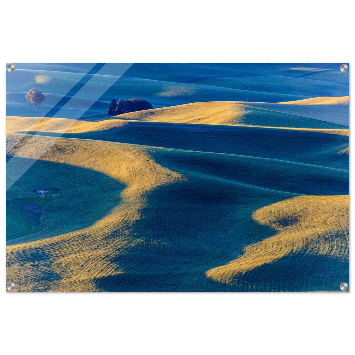 A landscape photography of an open green field and hills creating blue shadows. Acrylic.