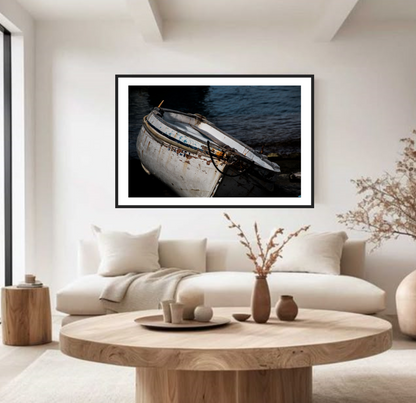 Framed artwork of a boat on water in a modern, rustic living room.