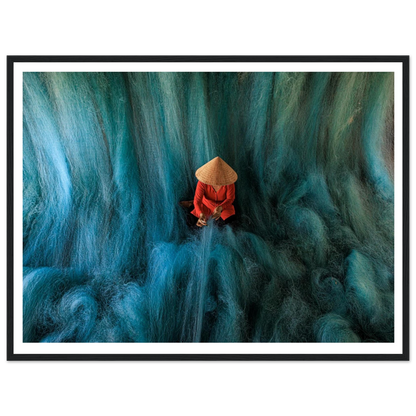 Person in a red outfit and straw hat sitting on a textured blue surface