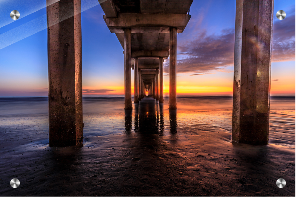 Sunset under a pier with water reflections