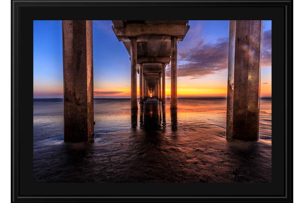 Sunset view under a pier with columns and water reflection