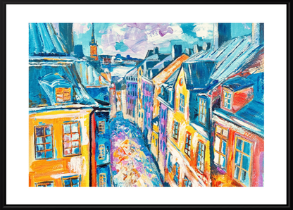 Framed painting of a colorful street scene with buildings and rooftops.