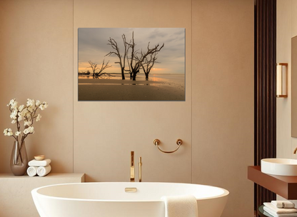 Bathroom interior with a bathtub, decorative vase with flowers, and wall art of trees on a beach printed in metallic.