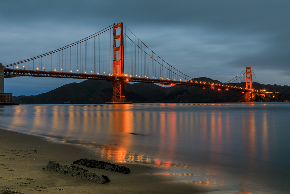 Golden Gate Bridge at night with water reflection