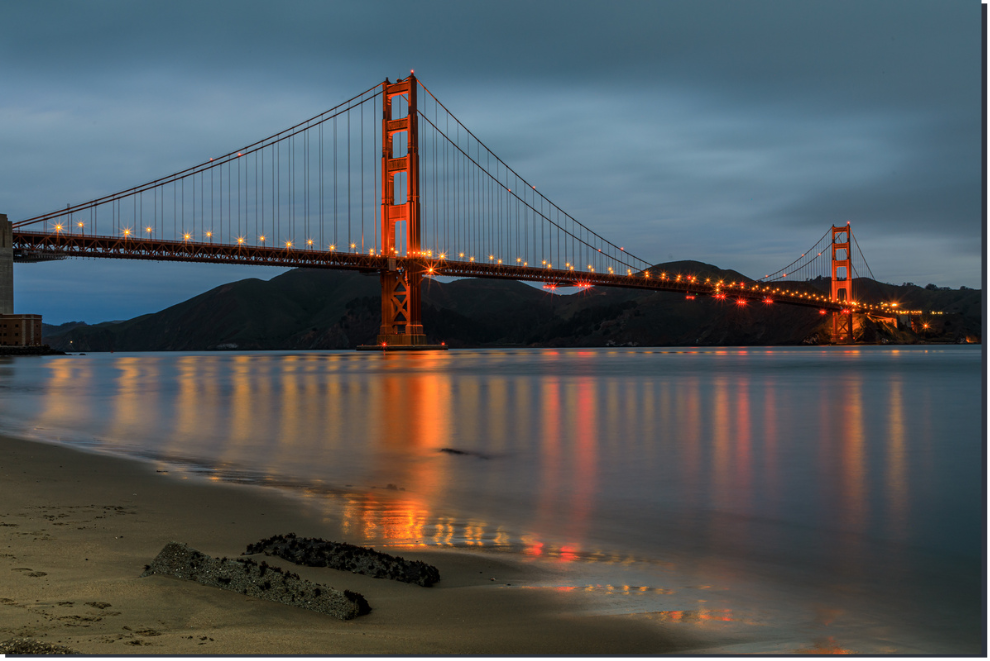 Golden Gate Bridge at dusk with reflection in water