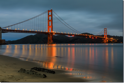Golden Gate Bridge at dusk with reflection in water