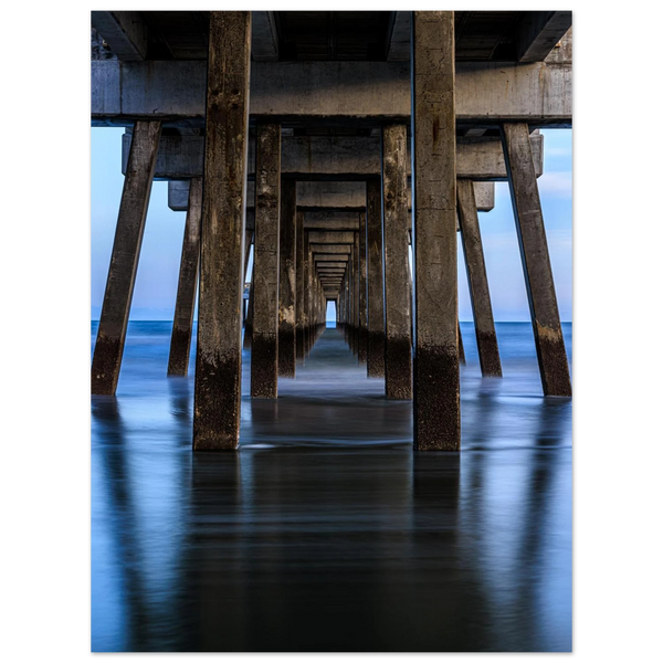 Fine art photo of a dock from below extending toward the sea horizon, evoking an infinite path and depth, suited for minimalist and romantic styles