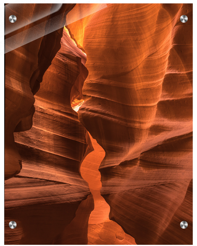 Narrow slot canyon with layered rock formations in a desert landscape