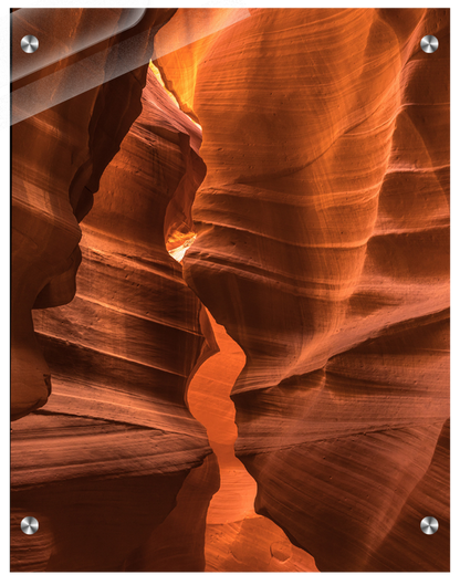 Narrow slot canyon with layered rock formations in a desert landscape