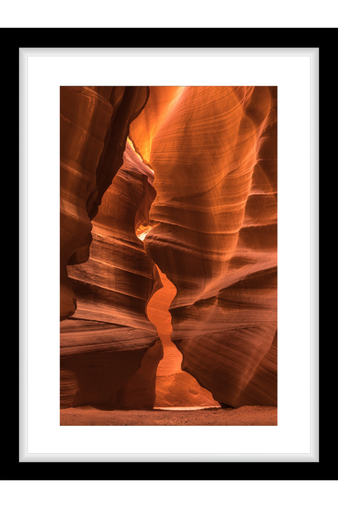 Framed photograph of a slot canyon with warm orange and brown tones.