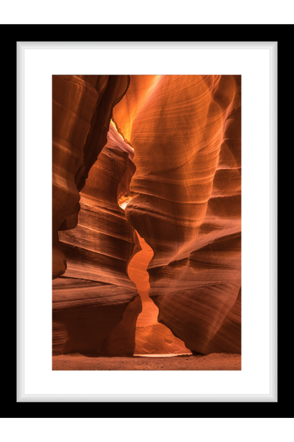 Framed photograph of a slot canyon with warm orange and brown tones.