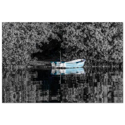 “Standing Out” captures a peaceful blue boat in contrast with black-and-white trees and water reflections. A soulful piece for minimalist and romantic homes.