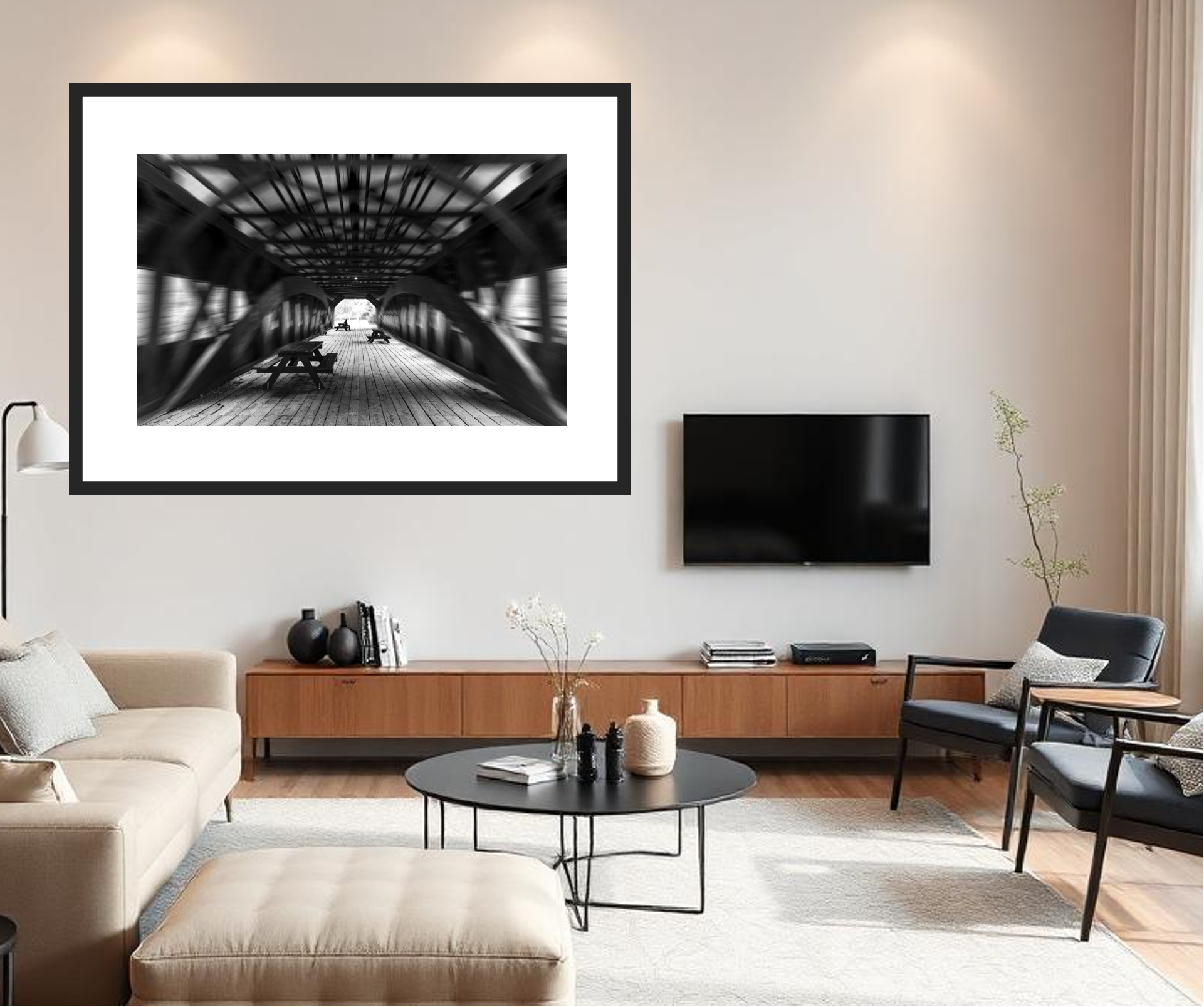 Modern living room with a framed black and white photo, television, and furniture.