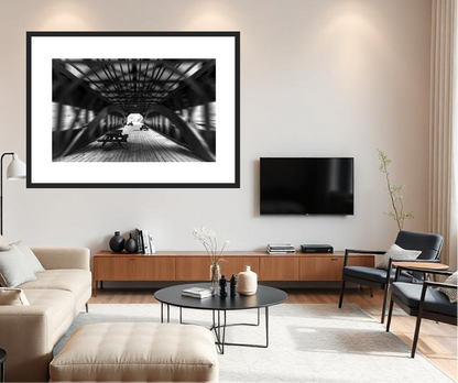 Modern living room with a framed black and white photo, television, and furniture.